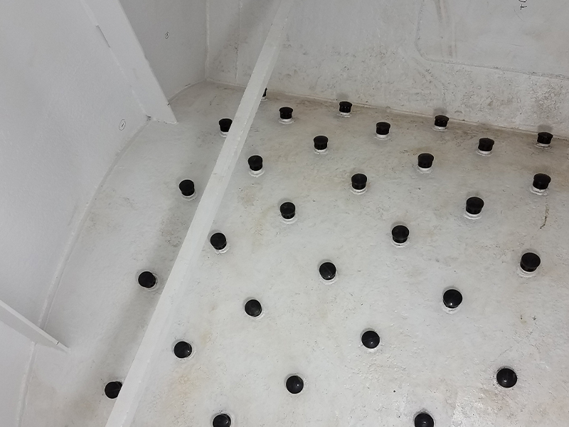 Figure 2: Horizontal pressure filter arched-plate underdrain with new nozzles following blasting and painting of internal steel surfaces.